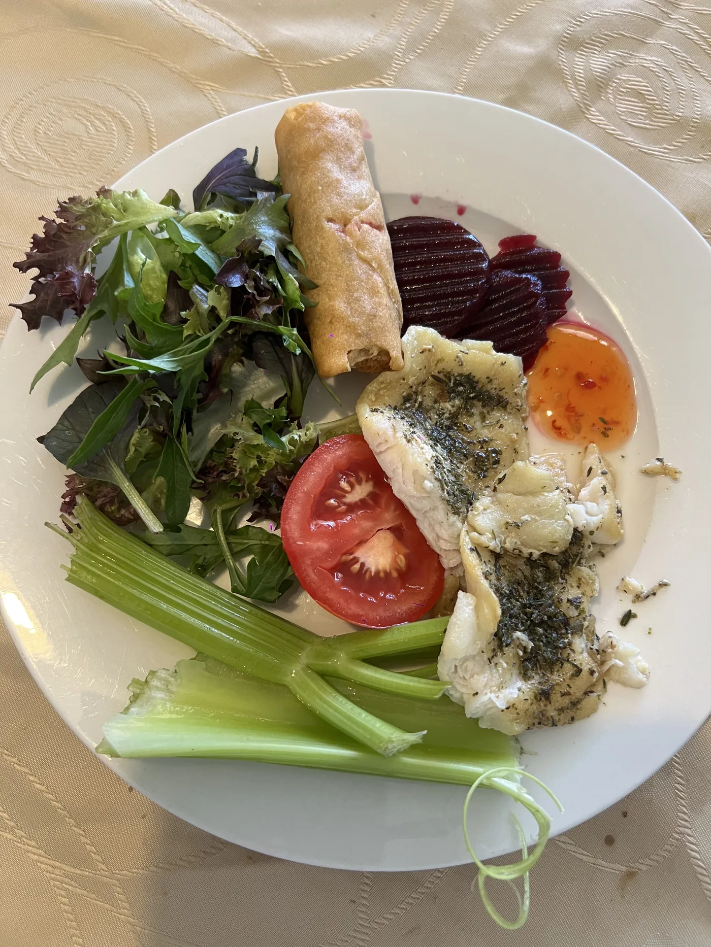 Plate with fish, celery, salad, beetroot and tomato